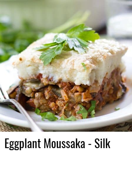 Close Up of a Slice of Vegan Eggplant Moussaka on a Plate with Fork
