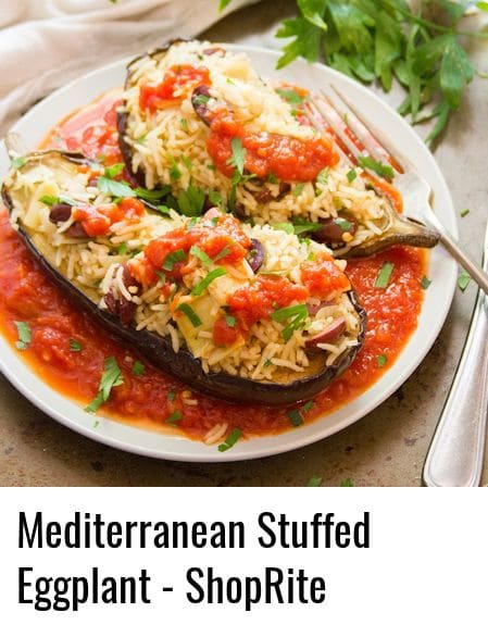 Two Halves of a Mediterranean Stuffed Eggplant on a Plate with Fork