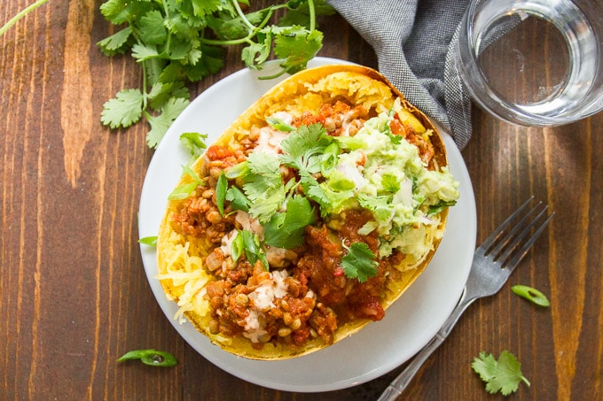 Overhead View of Taco Stuffed Spaghetti Squash with Fork and Drinking Glass