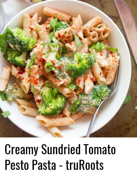 Bowl of Creamy Sundried Tomato Pasta with Broccoli Topped with Red Pepper Flakes