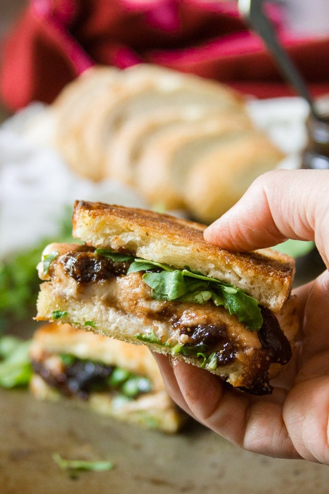 Hand Holding Half of a Vegan Mozzarella & Fig Jam Grilled Cheese Sandwich