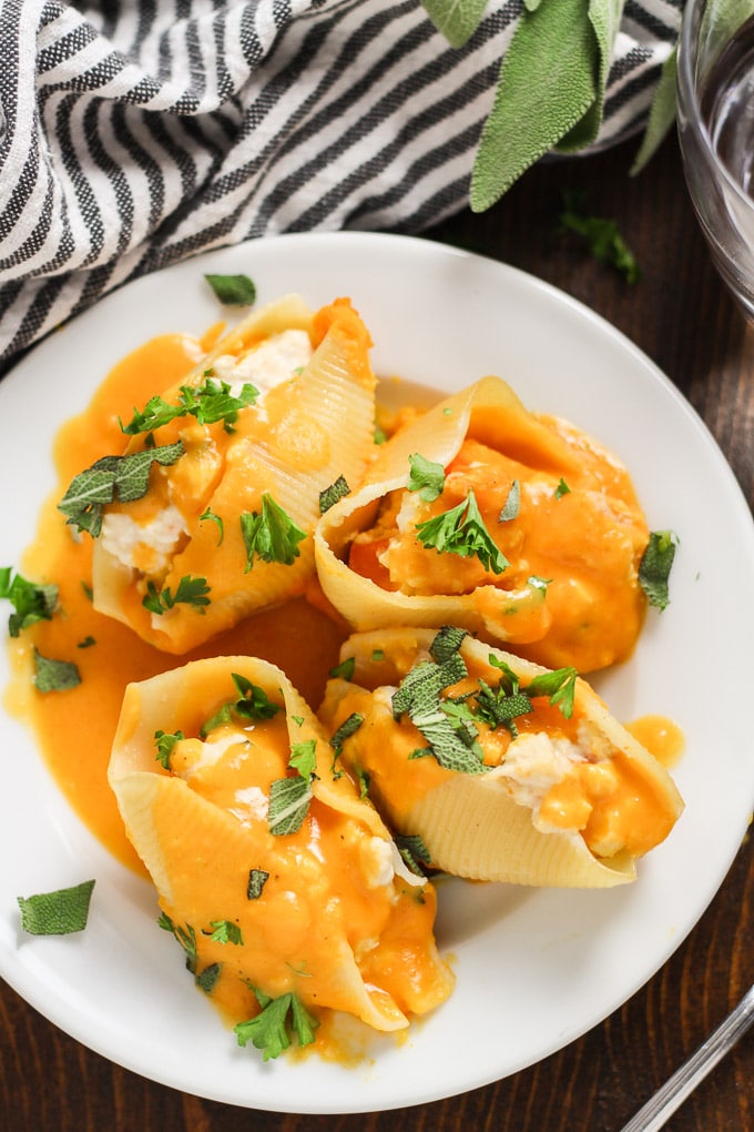 Overhead View of Vegan Butternut Squash Stuffed Shells on a Plate with Fork and Drinking Glass
