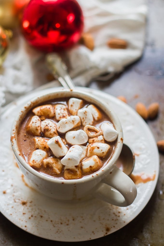 Cup of Vegan Hot Chocolate on a Saucer Topped with Marshmallows.