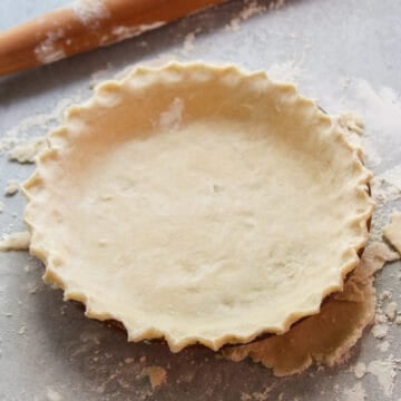 Vegan Pie Crust with Rolling pin in the background.