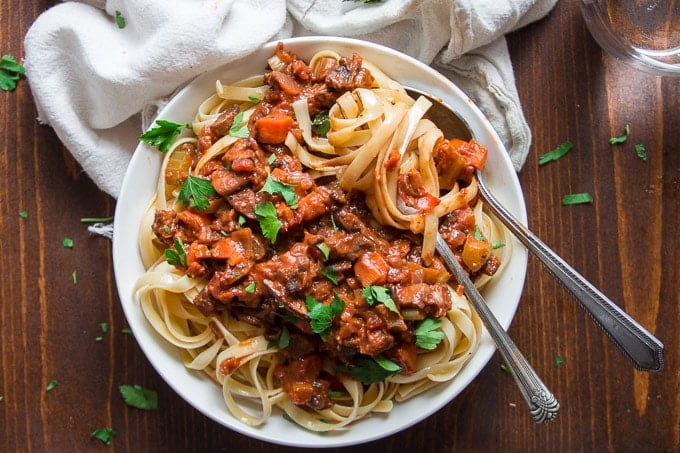 Close Up of a Bowl of Pasta with Mushroom Bolognese with Fork and Spoon