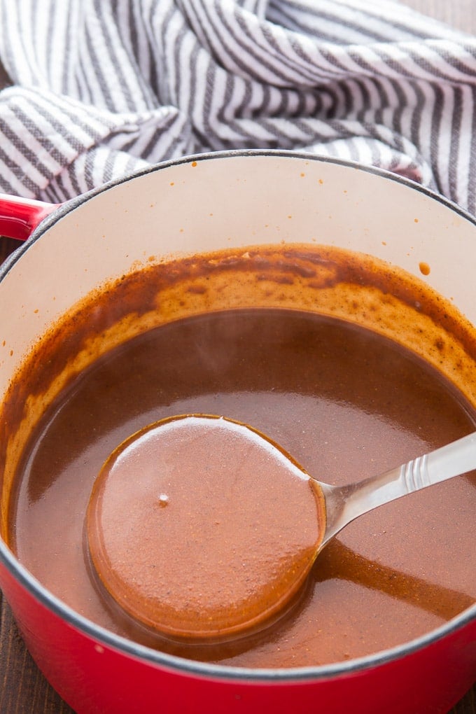 Ladle Drawing Enchilada Sauce from a Pot