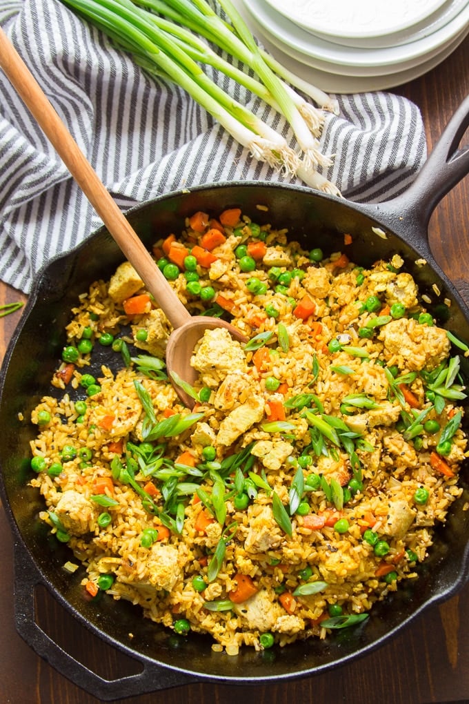 Skillet Filled with Curry Fried Rice with Serving Spoon