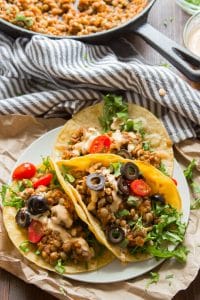 Vegan Lentil Tacos on a Plate with Skillet and Napkin in the Background