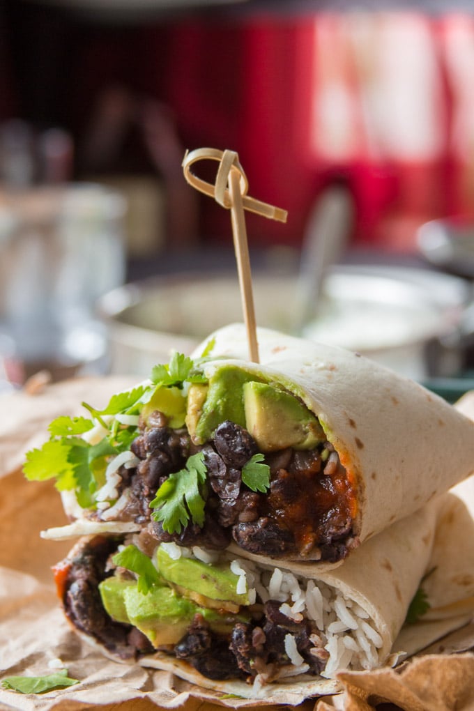 Two Halves of a Black Bean Burrito Stacked and Held Together with a Skewer