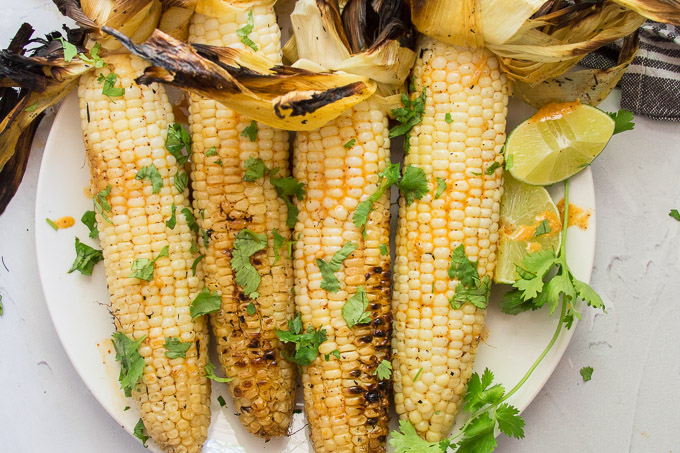 Close Up of 4 Ears of Mexican Grilled Corn Topped with Fresh Cilantro