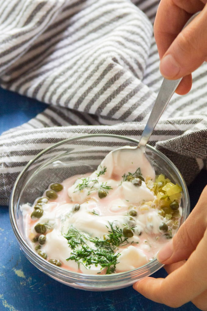 Hand Stirring Ingredients for Vegan Tartar Sauce Together in a Bowl