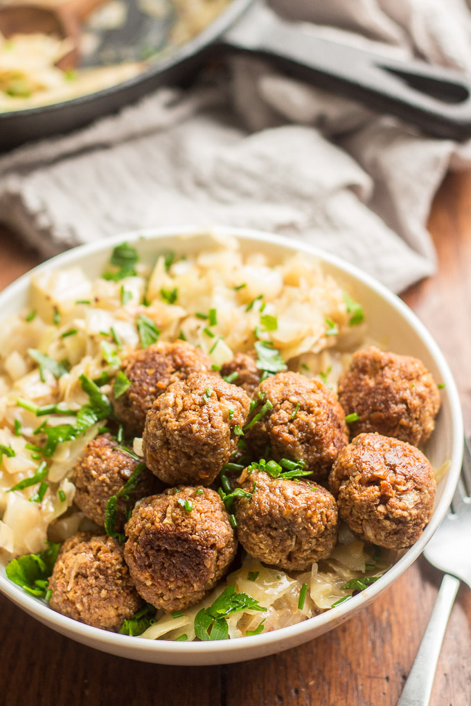 Close Up of Vegan German Meatballs & Cabbage in a Bowl with Chives on Top