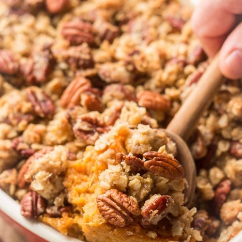Wooden Spoon Scooping Sweet Potato Casserole From a Baking Dish