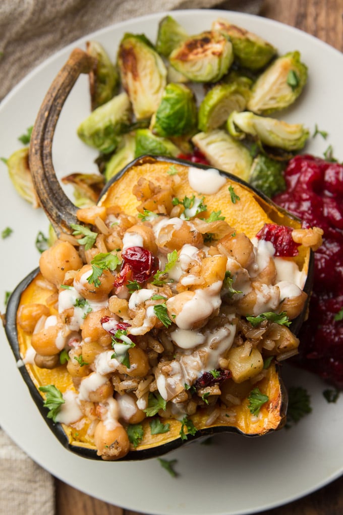 Stuffed Acorn Squash on a Plate with Brussels Sprouts and Cranberry Sauce
