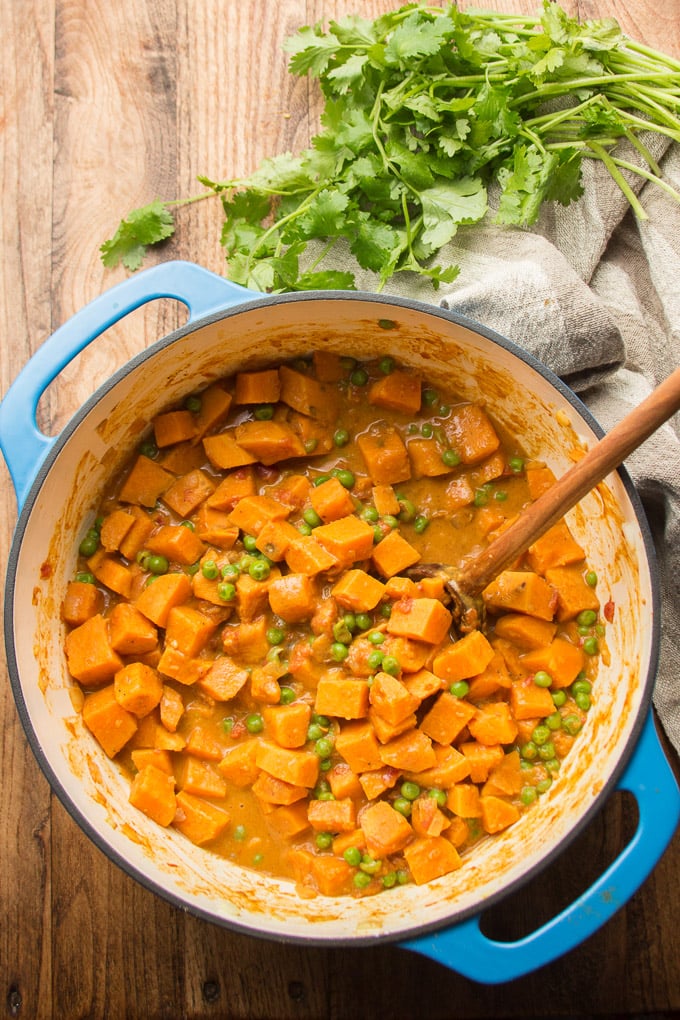 Pot Filled with Sweet Potato Curry with Wooden Spoon
