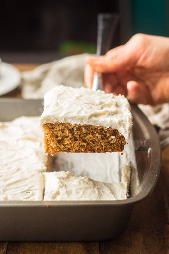 Hand Using a Cake Server to Remove a Slice of Vegan Spice Cake from a Pan