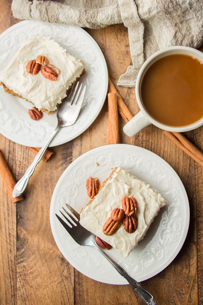Overhead View of a Wooden Table with Coffee Cup, Forks, and Two Plates of Spice Cake