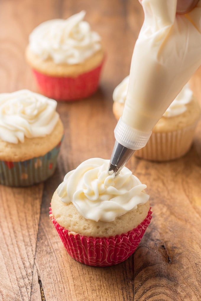 Frosting Being Piped onto a Vegan Vanilla Cupcake