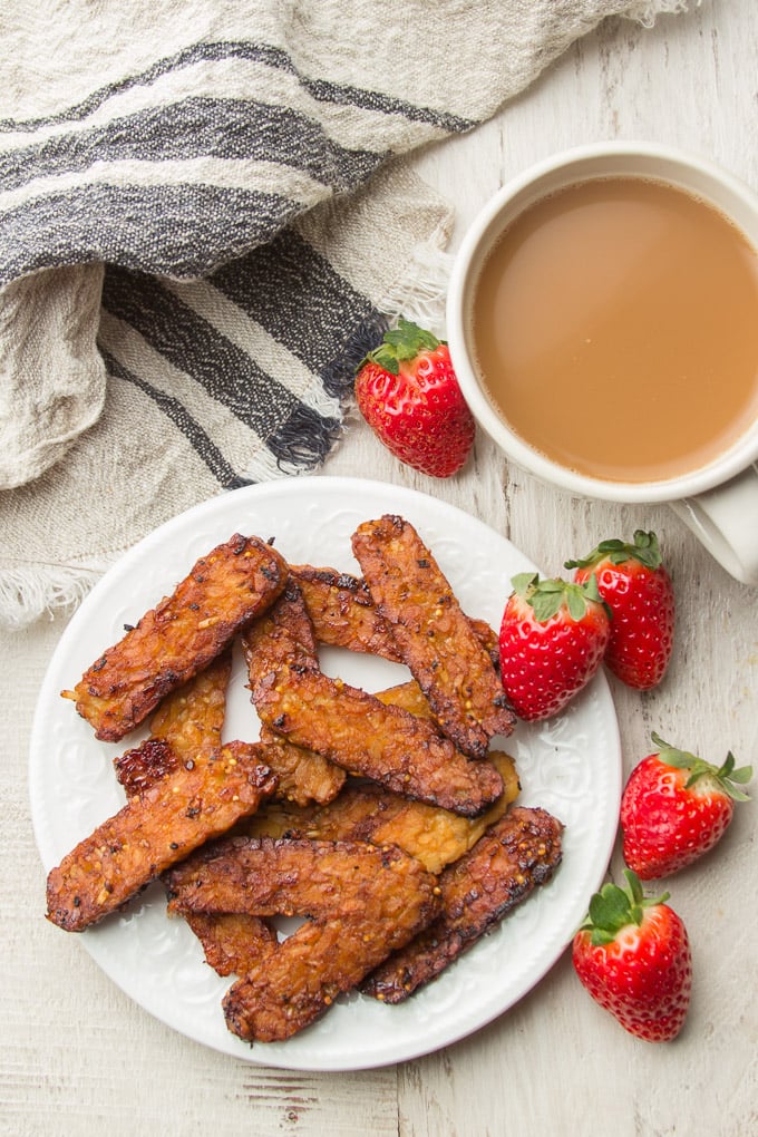 Plate of Tempeh Bacon with Strawberries and Cup of Coffee
