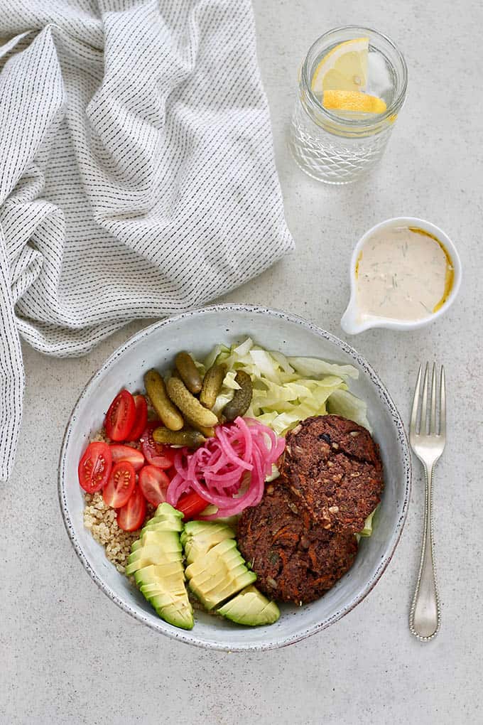 Veggie Burger in a Bowl with Fork and Dressing on the Side