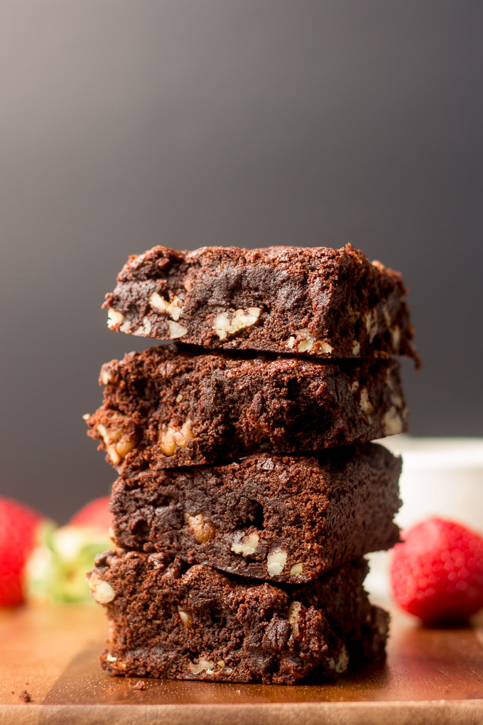 Stack of Vegan Brownies with Strawberries in the Background