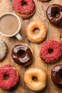Vegan Doughnuts on a Wooden Surface with a Cup of Coffee