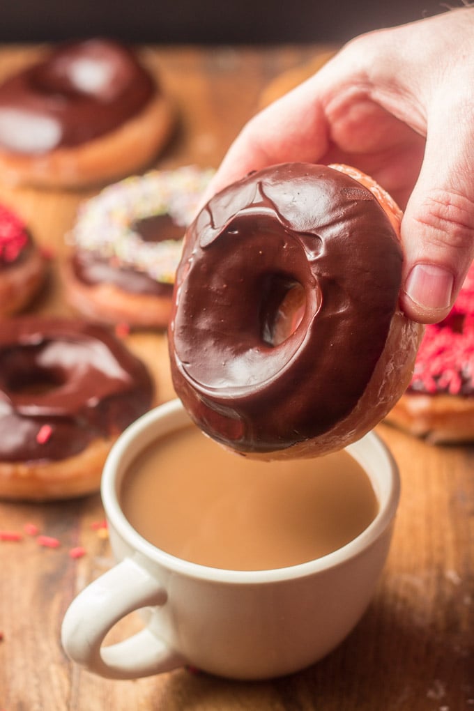 Hand Dipping a Vegan Doughnut into a Cup of Coffee
