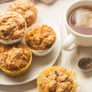 Vegan Carrot Muffins Arranged On a Table with a Cup of Tea