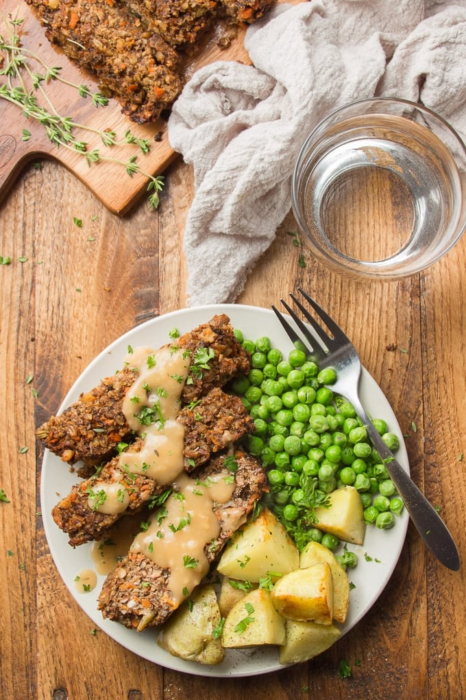 Table Set with Tea Towel, Water Glass, and Plate of Nut Roast, Peas and Potatoes