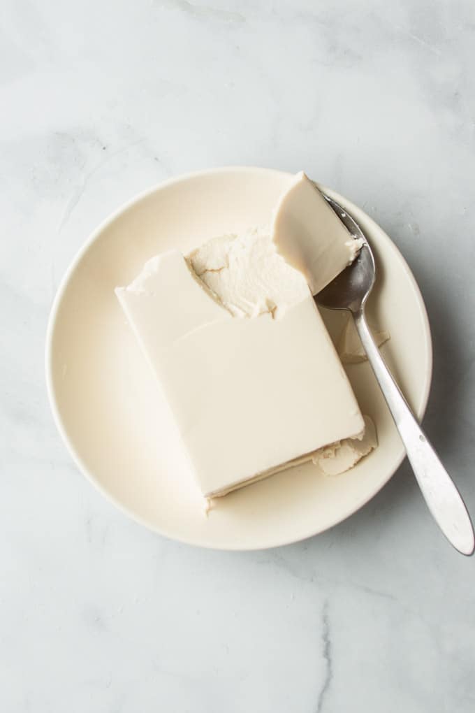 Block of Silken Tofu on a White Plate with Spoon