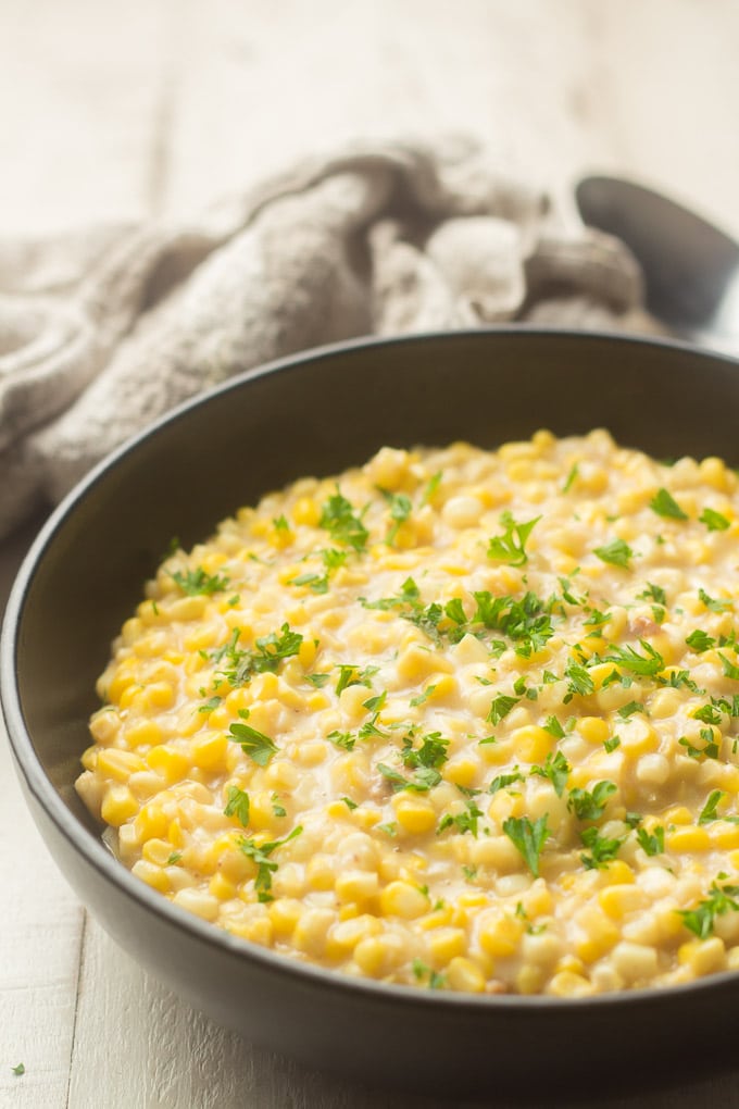 Close Up of a Bowl of Vegan Creamed Corn Topped with Parsley