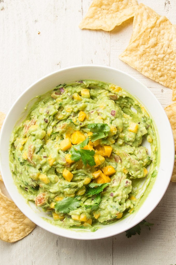 Mango Guacamole in a Bowl Surrounded by Chips