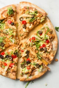 Sliced Vegan Taco Pizza on a Pizza Stone