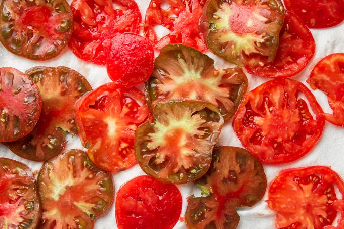 Salted Tomato Slices on a Paper Towel-Lined Baking Sheet