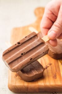 Hand Grabbing a Vegan Fudgesicle From a Stack