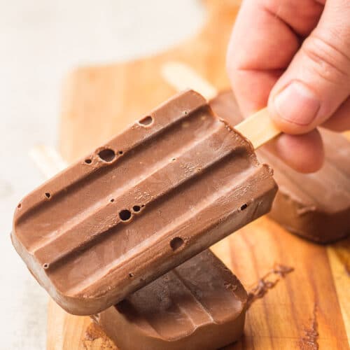 Hand Grabbing a Vegan Fudgesicle From a Stack