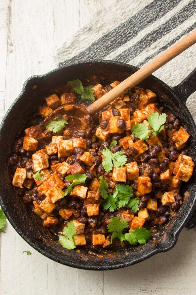 Cast Iron Skillet Filled with Tofu and Black Bean Burrito Bowl Filling