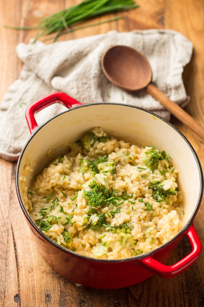 Pot of Vegan Broccoli Cheese Risotto with Napkin and Wooden Spoon in the Background