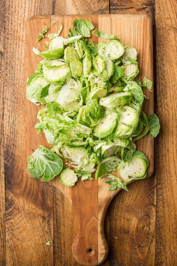 Thinly Sliced Brussels Sprouts on a Cutting Board