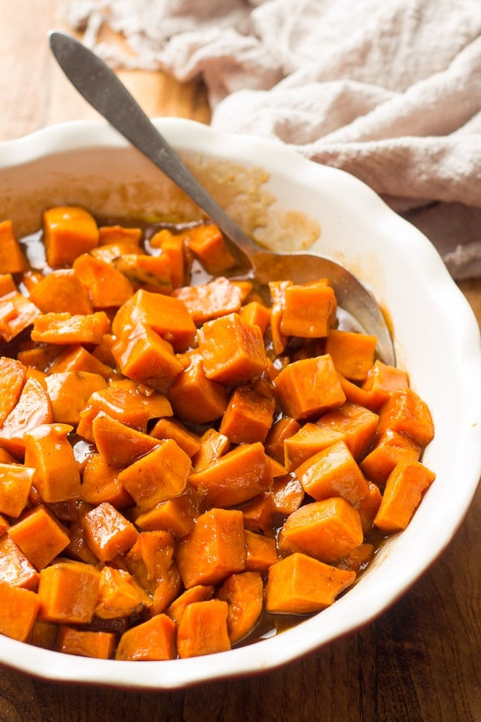 Close Up of Vegan Candied Yams in a Dish with Serving Spoon