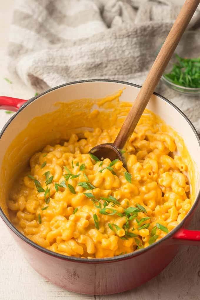 Pot of Vegan Butternut Squash Mac & Cheese and Chives with Wooden Spoon