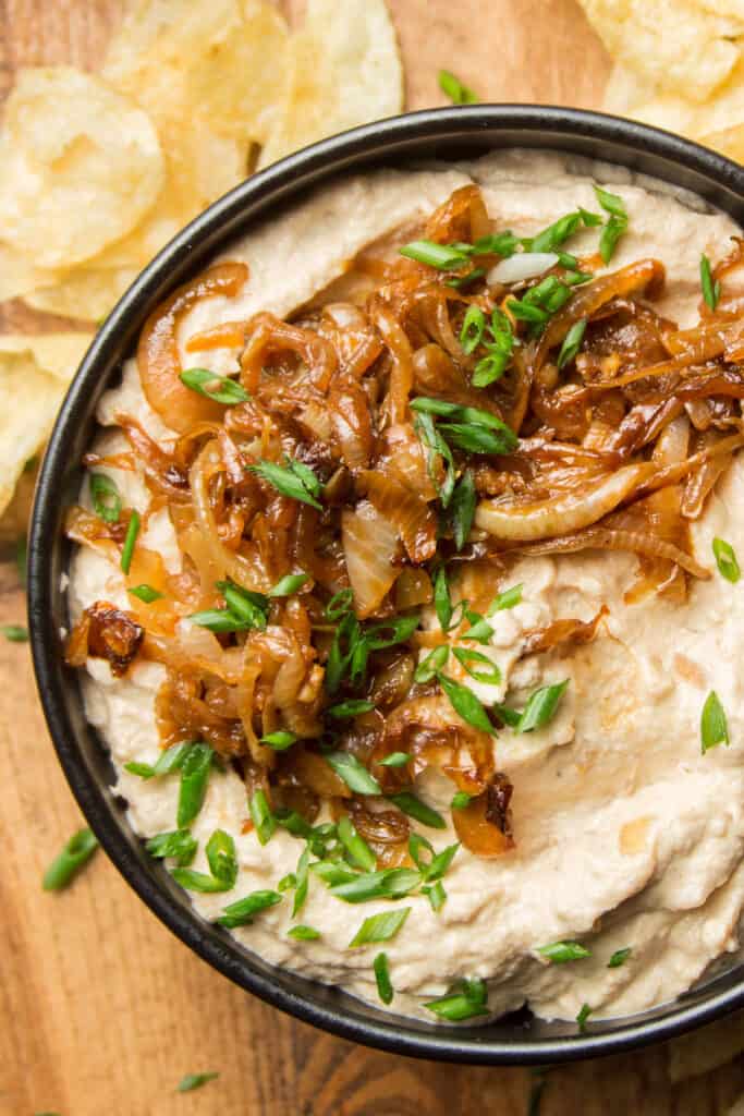 Close Up of a Bowl of Vegan French Onion Dip Topped with Caramelized Onions and Chives