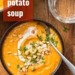 Bowl of Sweet Potato Soup with Spoon and Text Overlay Reading "Sweet Potato Soup"
