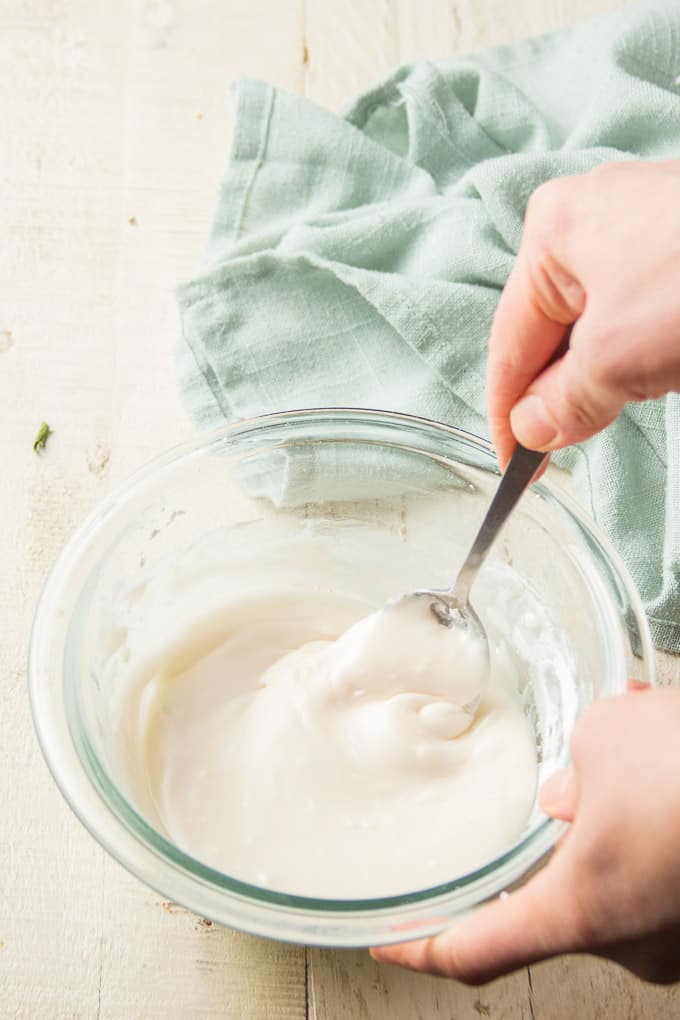 Hand Stirring Frosting Together in a Bowl