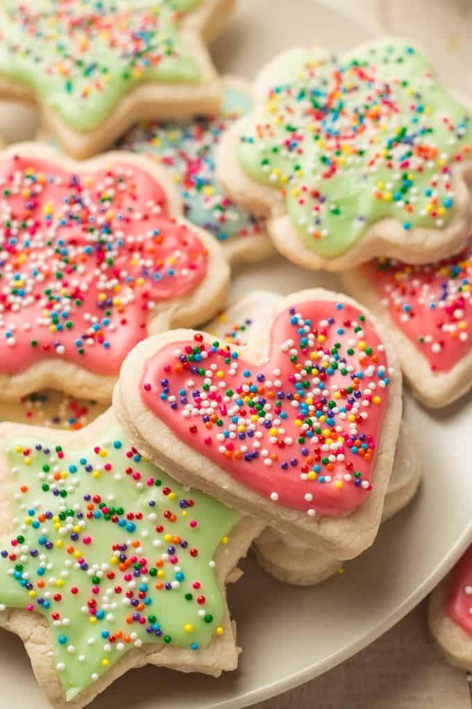 Vegan Sugar Cookies Topped with Frosting and Sprinkles on a Plate