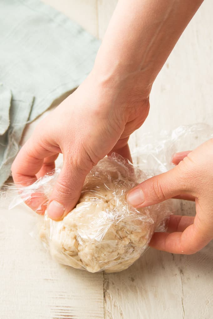 Hand Wrapping a Ball of Cookie Dough in Plastic