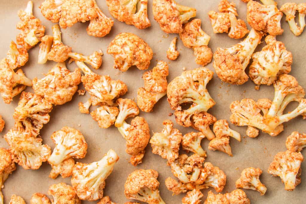 Cauliflower Florets Coated with Spices on Parchment Paper