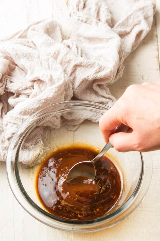 Hand Stirring Pad Thai Sauce Together in a Bowl