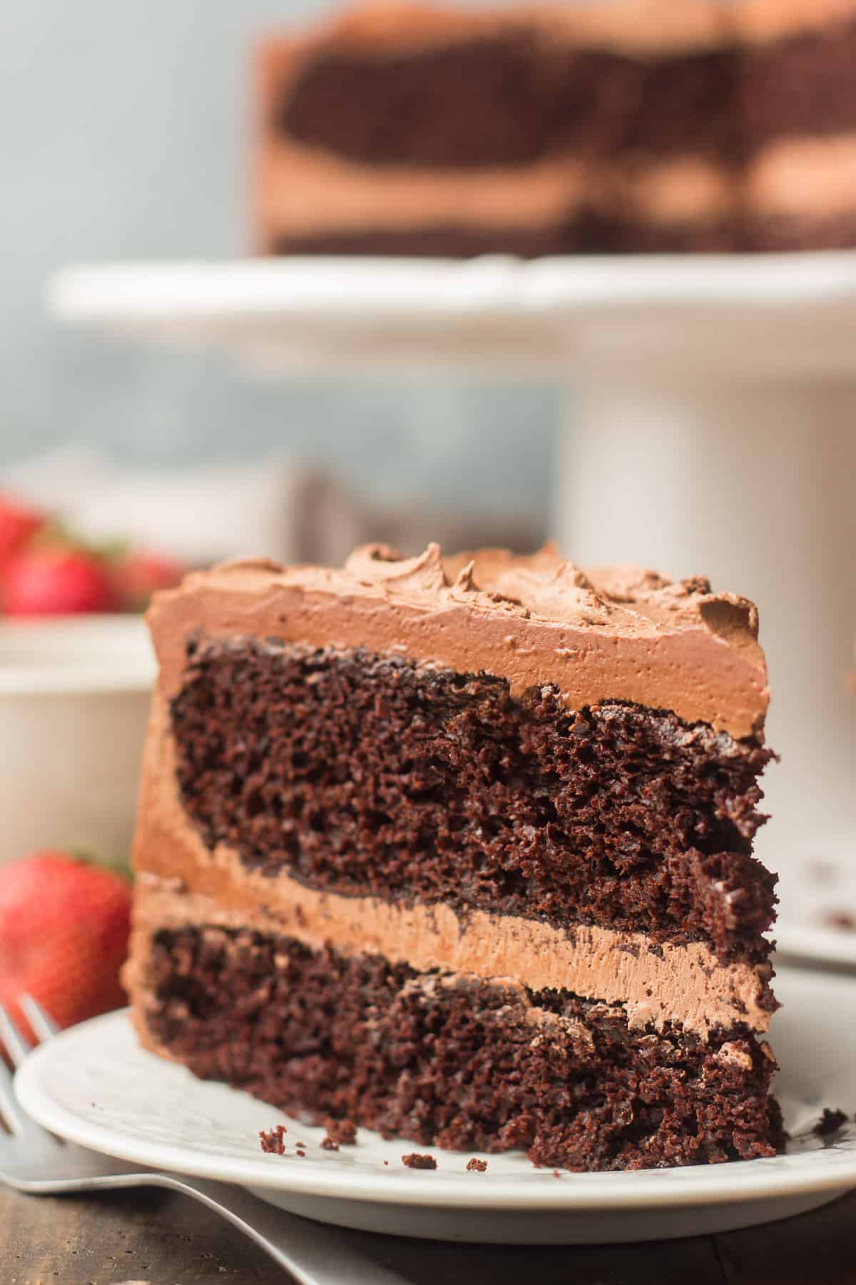 Close Up of a Slice of Vegan Chocolate Cake Standing Upright on a Plate
