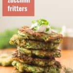 Stack of Vegan Zucchini Fritters with Text Overlay Reading "Vegan Zucchini Fritters"